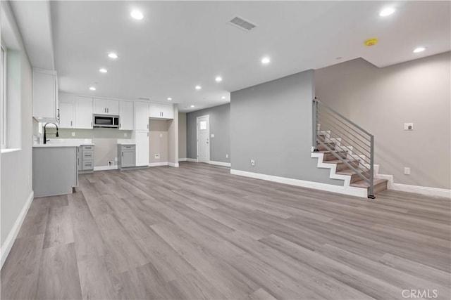 22022 Pioneer Blvd Unit A & B, Hawaiian Gardens, CA 90716 - unfurnished living room with recessed lighting, stairs, and light wood-style floors