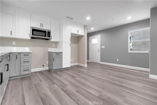 22022 Pioneer Blvd Unit A & B, Hawaiian Gardens, CA 90716 - kitchen with stainless steel microwave, light wood-style flooring, recessed lighting, white cabinets, and light stone countertops