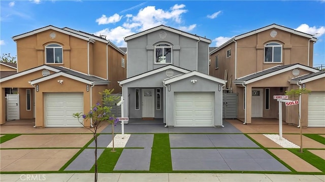 22022 Pioneer Blvd Unit A & B, Hawaiian Gardens, CA 90716 - view of front of home with stucco siding, concrete driveway, and a garage