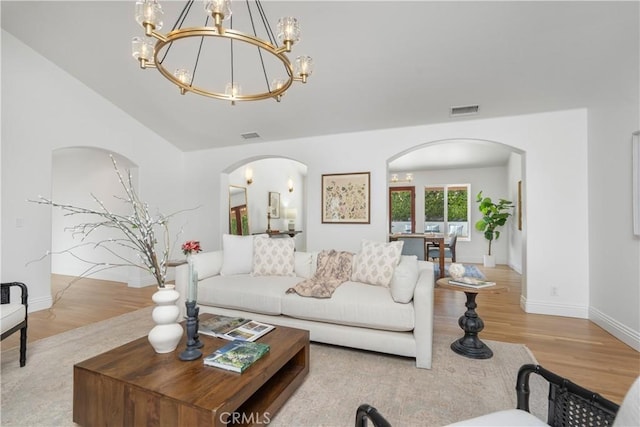 1247 Journeys End Dr, La Canada Flintridge, CA 91011 - living room with arched walkways, wood finished floors, a chandelier, and lofted ceiling