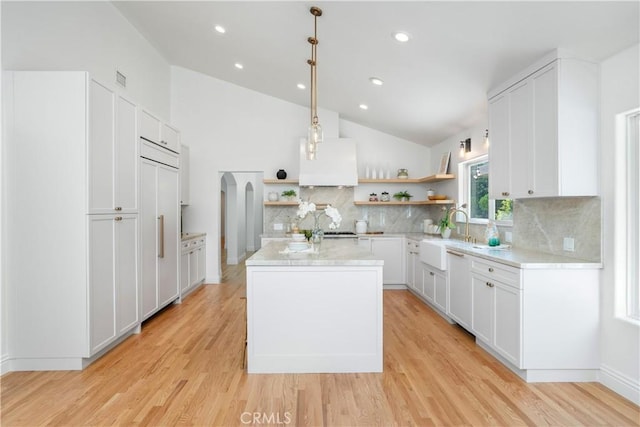 1247 Journeys End Dr, La Canada Flintridge, CA 91011 - kitchen with open shelves, vaulted ceiling, a center island, backsplash, and light wood-type flooring