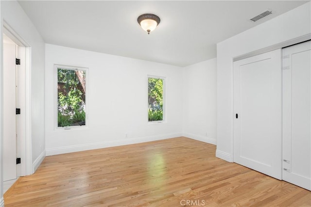 1247 Journeys End Dr, La Canada Flintridge, CA 91011 - unfurnished bedroom with multiple windows, light wood-type flooring, and a closet