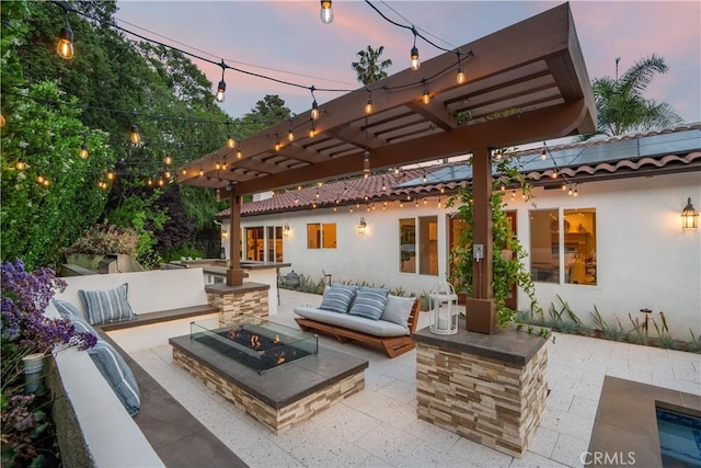1247 Journeys End Dr, La Canada Flintridge, CA 91011 - patio terrace at dusk featuring an outdoor living space with a fire pit, a patio, and a pergola