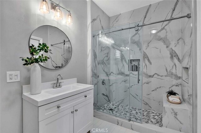343 W Fletcher Ave, Orange, CA 92865 - bathroom featuring vanity, a marble finish shower, and marble look tiles