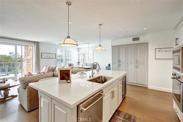 2393 Ocean St, Carlsbad, CA 92008 - kitchen featuring a sink, stainless steel appliances, open floor plan, light wood-style flooring, and recessed lighting