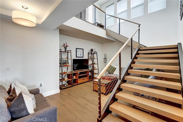 2393 Ocean St, Carlsbad, CA 92008 - living room with wood finished floors, stairs, baseboards, and a high ceiling