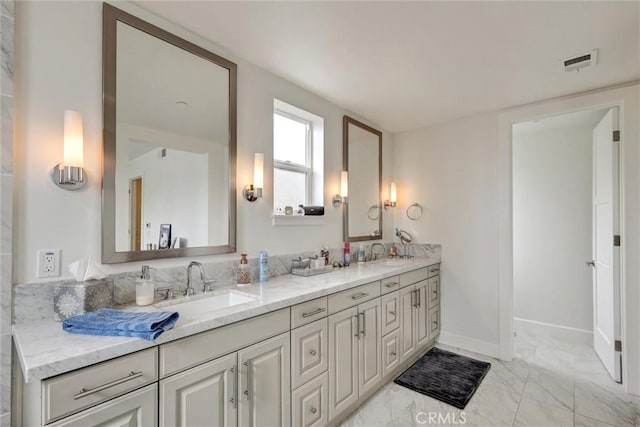2393 Ocean St, Carlsbad, CA 92008 - bathroom featuring double vanity, marble look tiles, and baseboards