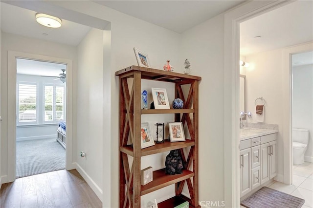 2393 Ocean St, Carlsbad, CA 92008 - hall featuring a sink, baseboards, and light wood-style flooring