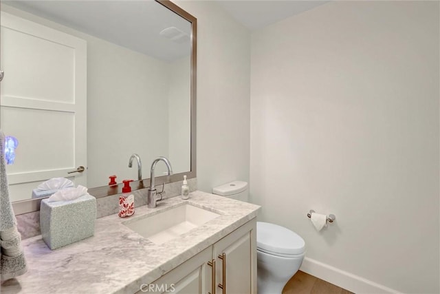 2393 Ocean St, Carlsbad, CA 92008 - bathroom with vanity, toilet, wood finished floors, and baseboards
