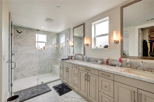 2393 Ocean St, Carlsbad, CA 92008 - bathroom with a shower stall, double vanity, a spacious closet, and marble look tile flooring