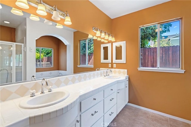 1550 Strawberry Ave, Arroyo Grande, CA 93420 - full bathroom featuring double vanity, a shower stall, tile patterned floors, baseboards, and a tub to relax in