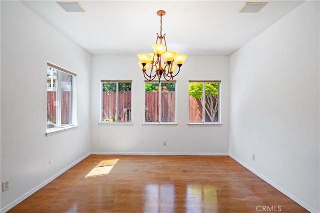 1550 Strawberry Ave, Arroyo Grande, CA 93420 - spare room featuring a chandelier, wood finished floors, and baseboards