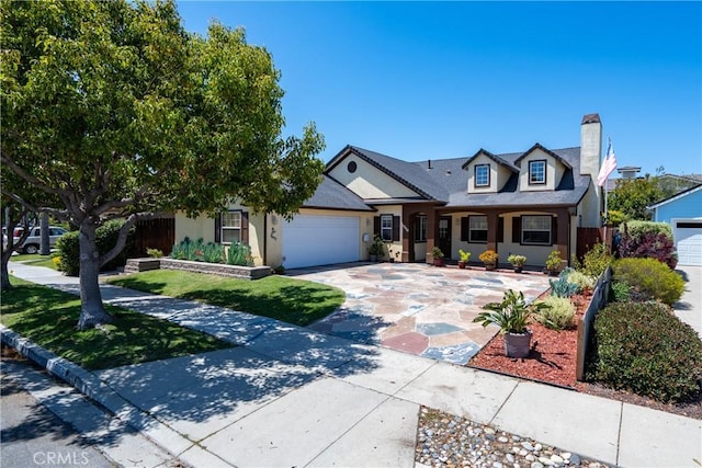 1550 Strawberry Ave, Arroyo Grande, CA 93420 - view of front of home featuring an attached garage, a chimney, concrete driveway, and stucco siding
