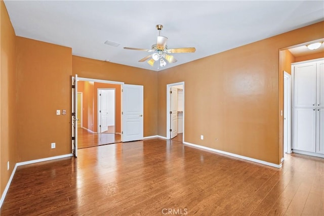 1550 Strawberry Ave, Arroyo Grande, CA 93420 - unfurnished bedroom featuring wood finished floors, baseboards, a spacious closet, a closet, and a ceiling fan