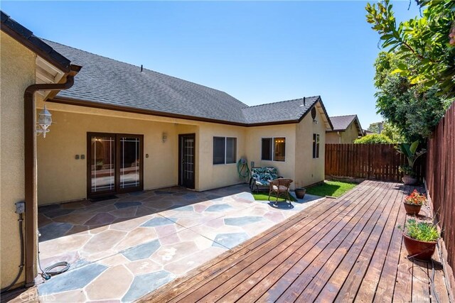 1550 Strawberry Ave, Arroyo Grande, CA 93420 - rear view of house with roof with shingles, a fenced backyard, stucco siding, a patio area, and a wooden deck