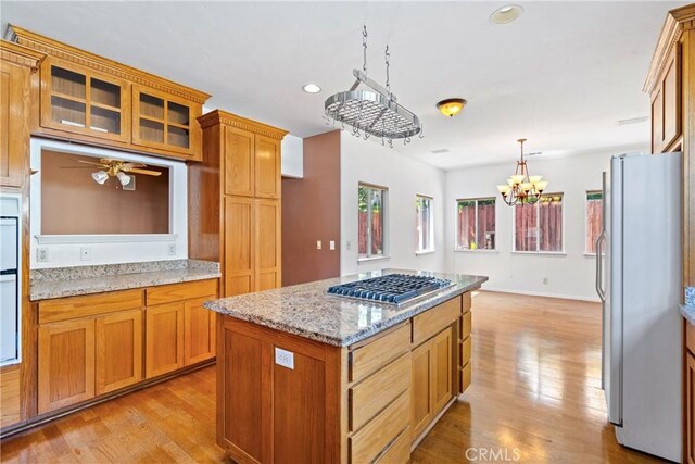 1550 Strawberry Ave, Arroyo Grande, CA 93420 - kitchen featuring freestanding refrigerator, stainless steel gas stovetop, light wood finished floors, recessed lighting, and a center island