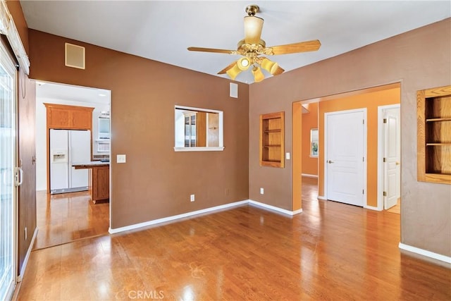 1550 Strawberry Ave, Arroyo Grande, CA 93420 - empty room with light wood-style floors, ceiling fan, baseboards, and built in shelves