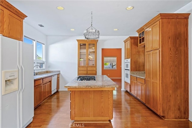 1550 Strawberry Ave, Arroyo Grande, CA 93420 - kitchen featuring white appliances, a center island, glass insert cabinets, wood finished floors, and recessed lighting