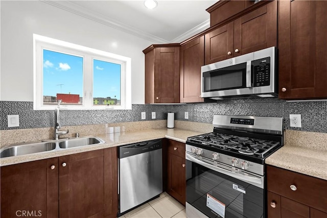 5633 Carlton Way Unit 503, Hollywood, CA 90028 - kitchen with stainless steel appliances, a sink, crown molding, tasteful backsplash, and light tile patterned floors
