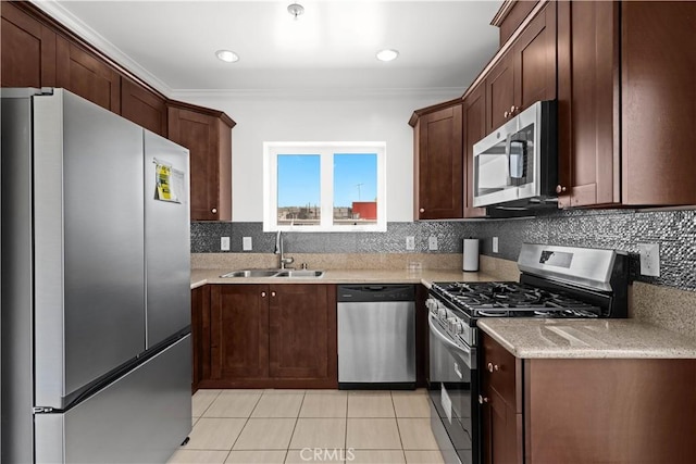 5633 Carlton Way Unit 503, Hollywood, CA 90028 - kitchen with appliances with stainless steel finishes, a sink, light tile patterned flooring, ornamental molding, and backsplash