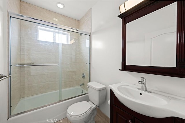 5633 Carlton Way Unit 503, Hollywood, CA 90028 - bathroom featuring toilet, vanity, and bath / shower combo with glass door