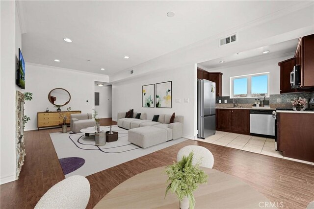 5633 Carlton Way Unit 503, Hollywood, CA 90028 - living room with ornamental molding, light wood finished floors, and recessed lighting