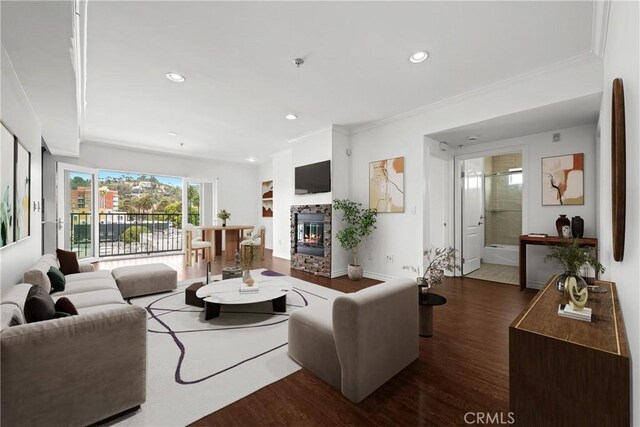 5633 Carlton Way Unit 503, Hollywood, CA 90028 - living room featuring wood finished floors, a stone fireplace, recessed lighting, and crown molding