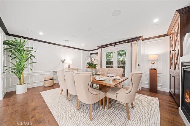 325 W Bellevue Dr, Pasadena, CA 91105 - dining space with a decorative wall, ornamental molding, dark wood-style floors, a lit fireplace, and recessed lighting