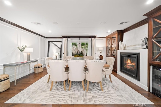 325 W Bellevue Dr, Pasadena, CA 91105 - dining room with a glass covered fireplace, ornamental molding, dark wood-style floors, a decorative wall, and wine cooler