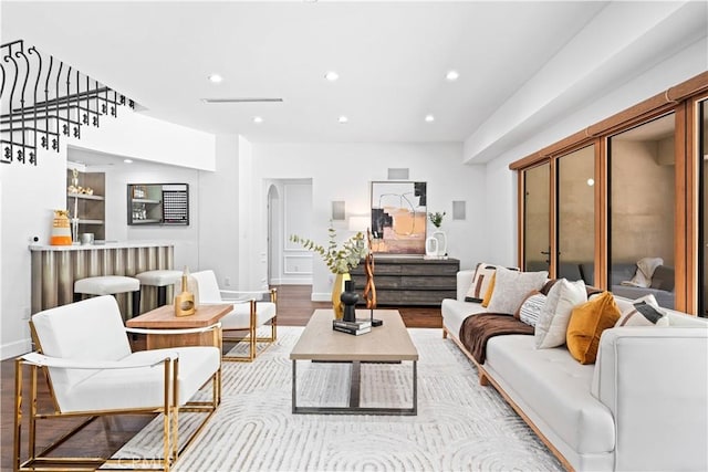325 W Bellevue Dr, Pasadena, CA 91105 - living room featuring wood finished floors, recessed lighting, stairway, arched walkways, and bar area