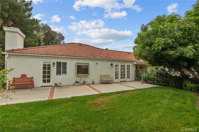 26320 Ivrea Pl, Valencia, CA 91355 - rear view of house with a lawn, a tiled roof, french doors, and stucco siding