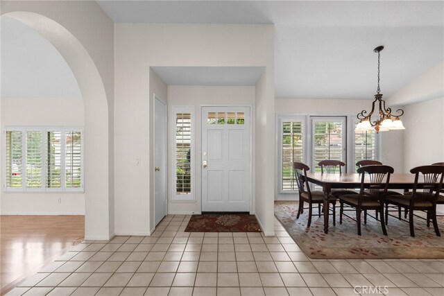 26320 Ivrea Pl, Valencia, CA 91355 - foyer featuring vaulted ceiling, arched walkways, plenty of natural light, a chandelier, and baseboards