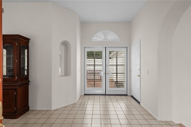 26320 Ivrea Pl, Valencia, CA 91355 - entryway with french doors, arched walkways, light tile patterned floors, and baseboards
