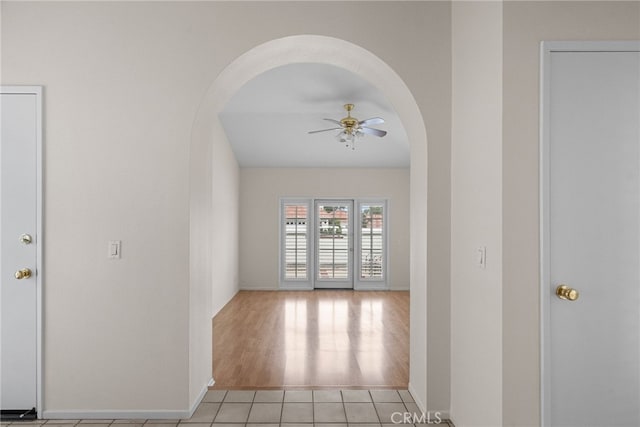 26320 Ivrea Pl, Valencia, CA 91355 - spare room with arched walkways, ceiling fan, baseboards, and light tile patterned flooring