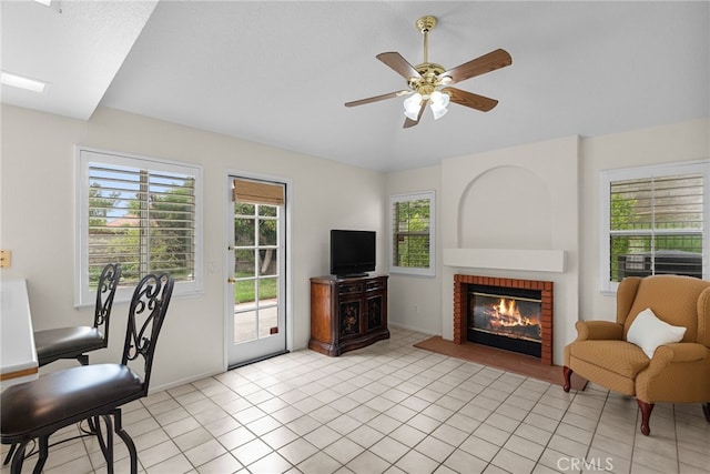 26320 Ivrea Pl, Valencia, CA 91355 - living area featuring a brick fireplace, ceiling fan, baseboards, light tile patterned floors, and vaulted ceiling