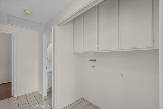 26320 Ivrea Pl, Valencia, CA 91355 - laundry room featuring cabinet space, light tile patterned floors, and baseboards