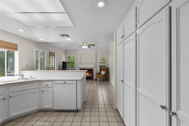 26320 Ivrea Pl, Valencia, CA 91355 - kitchen featuring dishwasher, a sink, a lit fireplace, white cabinets, and recessed lighting