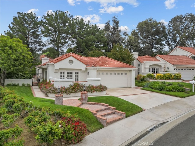 26320 Ivrea Pl, Valencia, CA 91355 - mediterranean / spanish house with a garage, driveway, a tiled roof, and stucco siding