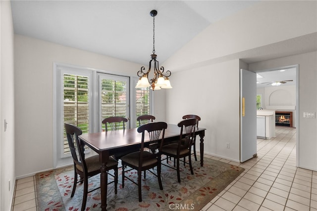 26320 Ivrea Pl, Valencia, CA 91355 - dining room featuring a chandelier, light tile patterned flooring, lofted ceiling, a glass covered fireplace, and baseboards