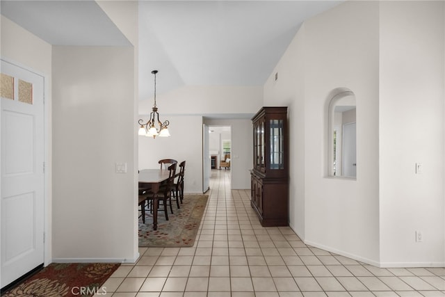 26320 Ivrea Pl, Valencia, CA 91355 - dining area featuring a chandelier, vaulted ceiling, light tile patterned floors, and baseboards