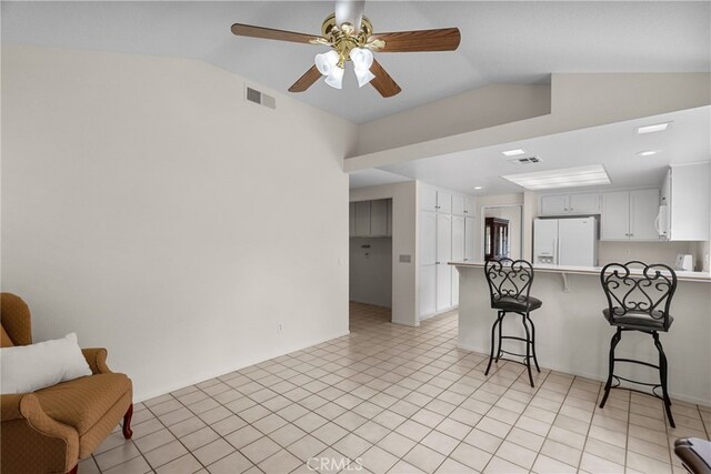 26320 Ivrea Pl, Valencia, CA 91355 - kitchen featuring white fridge with ice dispenser, lofted ceiling, a peninsula, a breakfast bar, and a ceiling fan