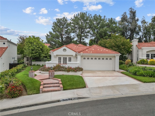 26320 Ivrea Pl, Valencia, CA 91355 - mediterranean / spanish-style home with an attached garage, a tiled roof, concrete driveway, and stucco siding