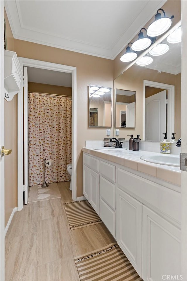 23556 Kathryn St, Murrieta, CA 92562 - bathroom featuring toilet, double vanity, wood finished floors, and crown molding