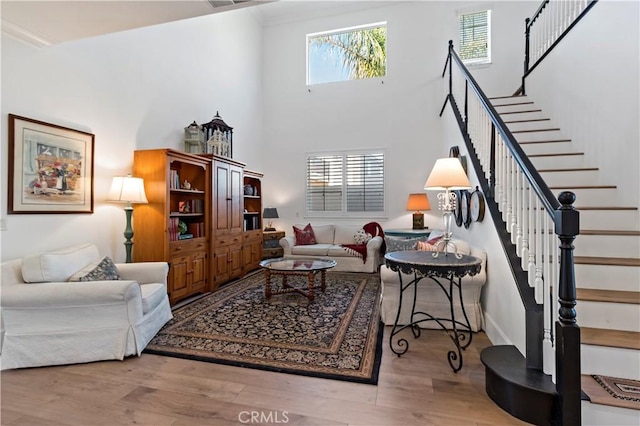 23556 Kathryn St, Murrieta, CA 92562 - living area with plenty of natural light, stairway, wood finished floors, and a high ceiling