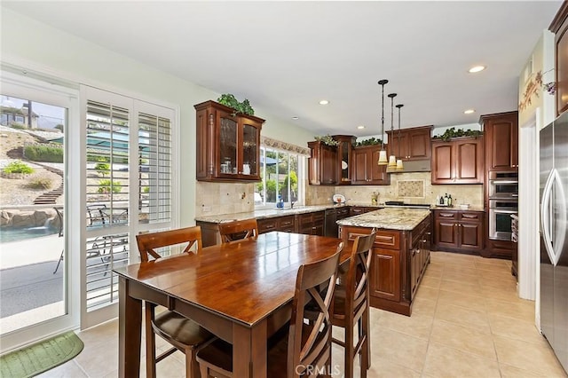 14160 Vai Brothers Dr, Rancho Cucamonga, CA 91739 - kitchen featuring stainless steel appliances, under cabinet range hood, light tile patterned floors, decorative backsplash, and recessed lighting