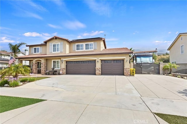 14160 Vai Brothers Dr, Rancho Cucamonga, CA 91739 - mediterranean / spanish-style home with concrete driveway, a gate, stone siding, and stucco siding
