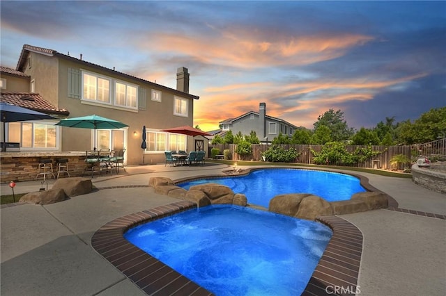 14160 Vai Brothers Dr, Rancho Cucamonga, CA 91739 - view of swimming pool featuring a patio area, a fenced backyard, outdoor dining area, and a pool with connected hot tub