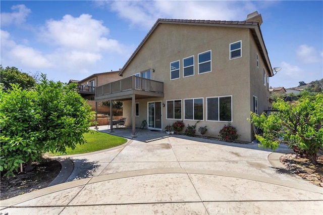 12178 Scenic Vw, Riverside, CA 92505 - back of property with stucco siding, a balcony, and a patio area