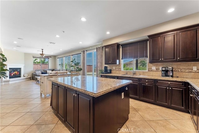 12178 Scenic Vw, Riverside, CA 92505 - kitchen with light tile patterned flooring, a sink, light stone counters, backsplash, and recessed lighting