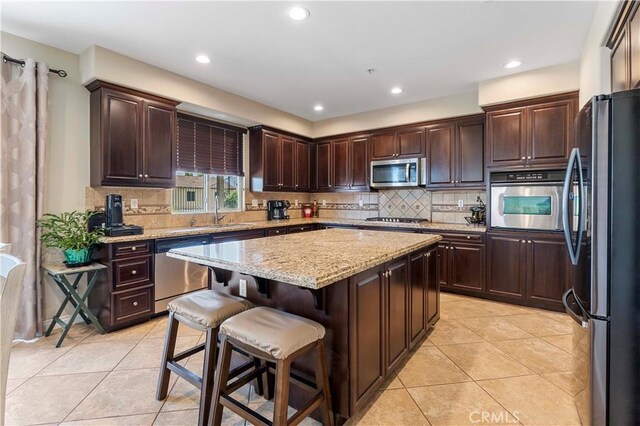 12178 Scenic Vw, Riverside, CA 92505 - kitchen with appliances with stainless steel finishes, a sink, a center island, light tile patterned floors, and recessed lighting